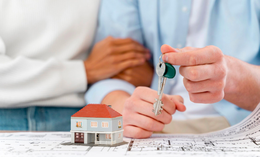 Couple holding keys to house they are renting